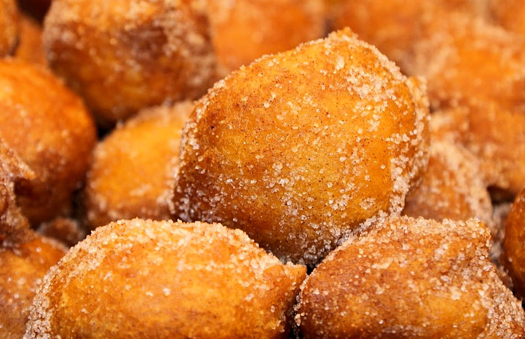 Discover the magic of Sonhos, traditional Portuguese doughnuts, as you indulge in the festive flavors of Lisbon's culinary heritage.