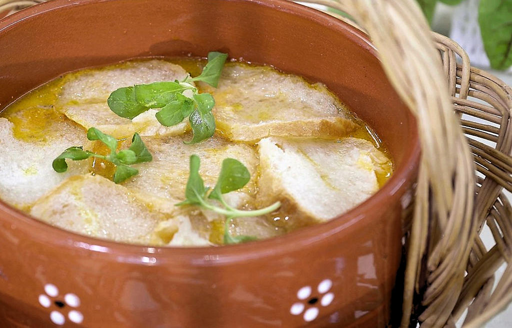 Savor the rich flavors of Sopa de Bacalhau dos Campinos, a traditional Portuguese soup from Azambuja, blending salted codfish, tomatoes, potatoes, and aromatic herbs, capturing the essence of Ribatejo's culinary heritage.