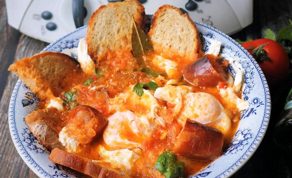 Indulge in the comforting flavors of Sopa de Tomate com Ovos Escalfados, a traditional Portuguese dish featuring tomato soup with poached eggs.